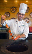 Chef Using Tandoor Oven 